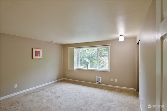 empty room featuring light colored carpet