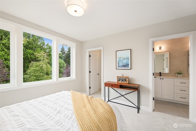 carpeted bedroom featuring ensuite bathroom