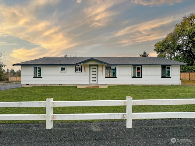 single story home featuring a yard