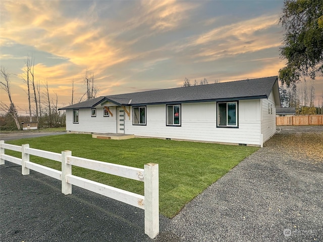 ranch-style home with a yard