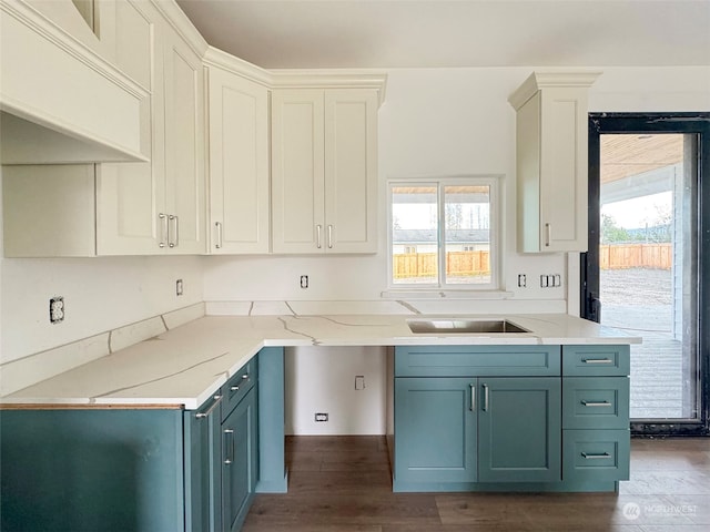 kitchen featuring white cabinets, a healthy amount of sunlight, and dark hardwood / wood-style floors