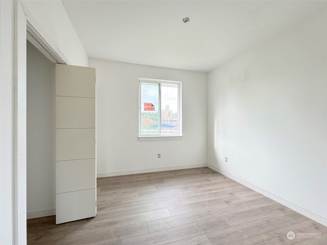 unfurnished room with light wood-type flooring