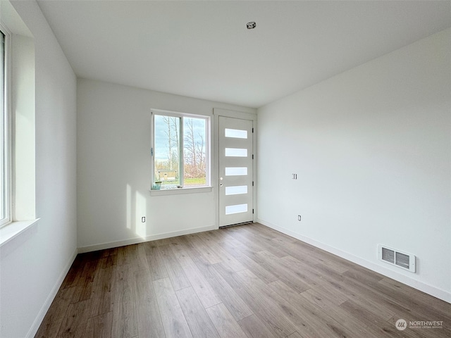 spare room featuring light hardwood / wood-style flooring