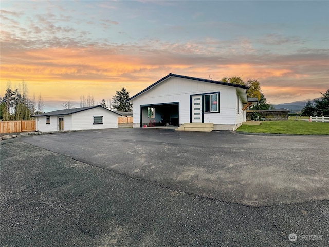 garage at dusk with a yard