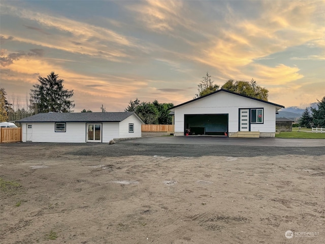 view of front of property with a garage and an outbuilding