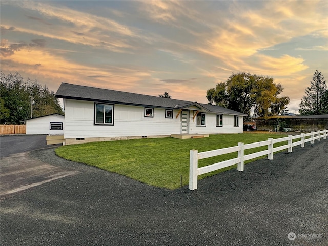 single story home with a yard