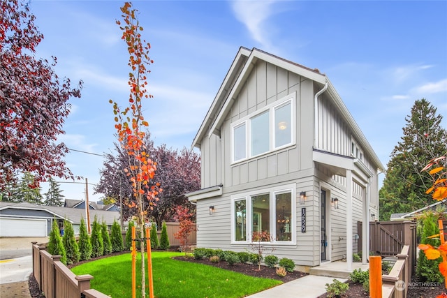 view of front of property with a front yard and a garage