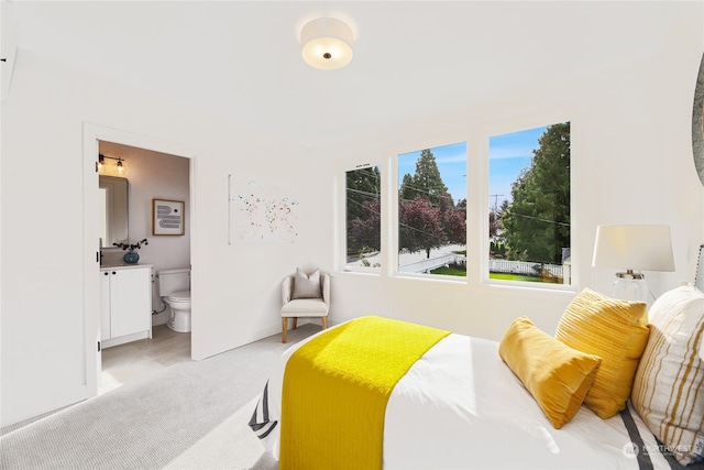 carpeted bedroom featuring ensuite bathroom