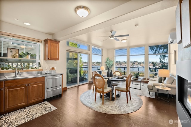 sunroom with a wall unit AC, sink, and ceiling fan