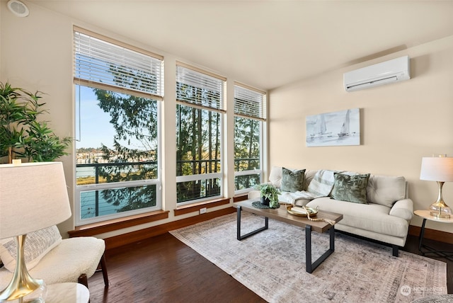 sunroom featuring a wall mounted AC and a healthy amount of sunlight