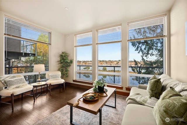 sunroom / solarium featuring plenty of natural light and a water view