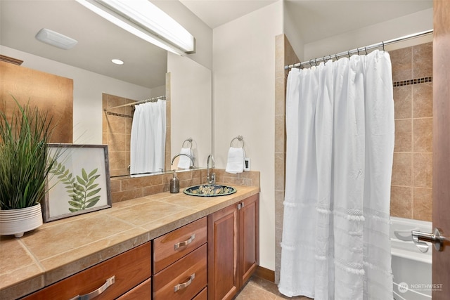 bathroom with walk in shower and vanity