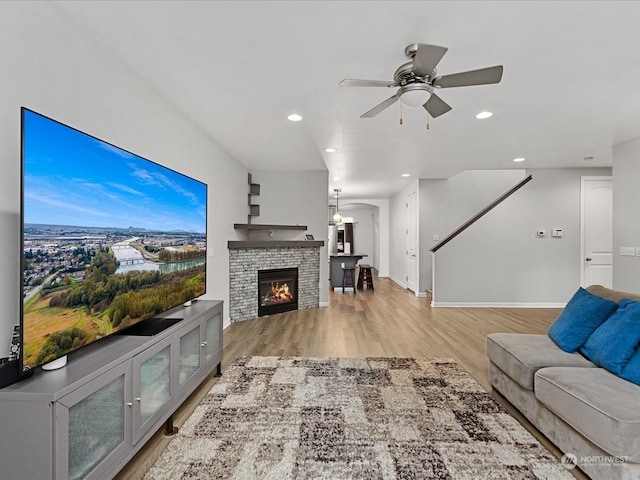 living room with ceiling fan and light hardwood / wood-style floors