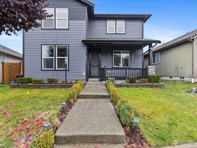 view of front facade featuring a porch and a front lawn