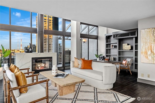 living room featuring a fireplace, hardwood / wood-style flooring, and floor to ceiling windows