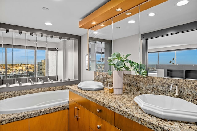 bathroom featuring vanity and a tub