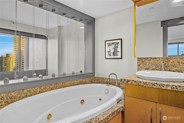 bathroom featuring a bathing tub, plenty of natural light, and vanity