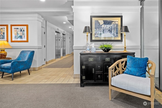 sitting room featuring elevator and carpet floors