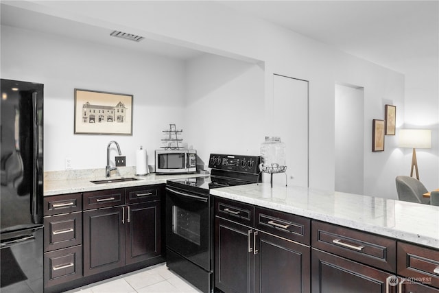 kitchen with dark brown cabinetry, sink, black appliances, light stone countertops, and light tile patterned floors