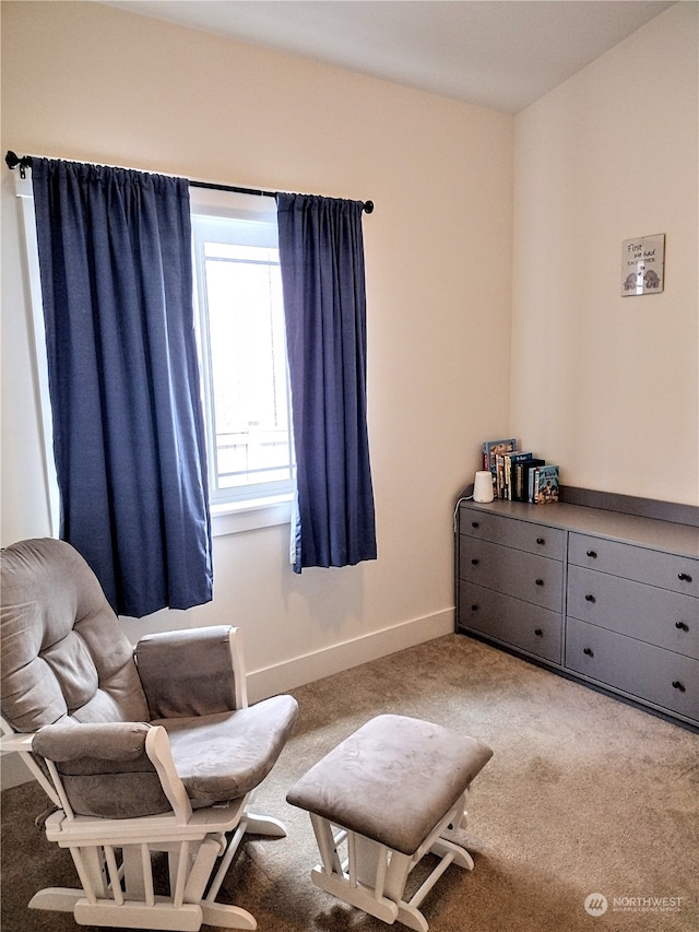 sitting room featuring light colored carpet