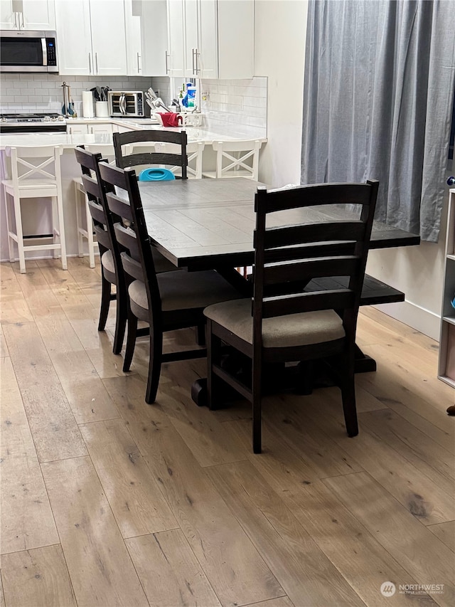 dining area with light hardwood / wood-style floors