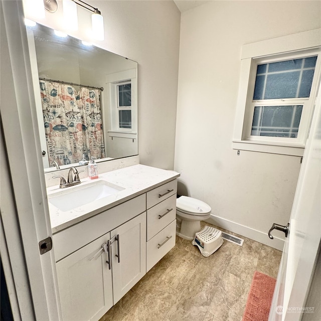 bathroom with vanity and toilet