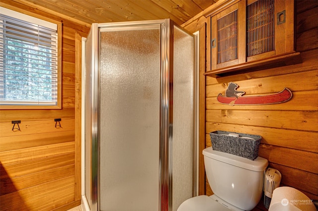 bathroom with toilet, wood walls, wood ceiling, and a shower with door