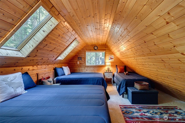 carpeted bedroom with wood walls, vaulted ceiling with skylight, and wood ceiling