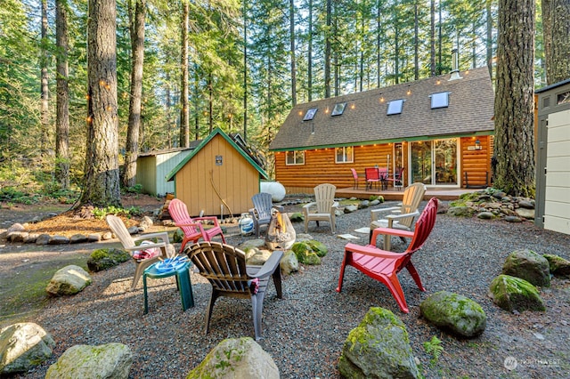 view of patio / terrace featuring an outdoor fire pit and a storage unit