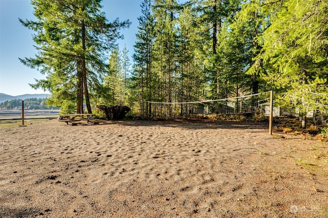 view of property's community with a mountain view and volleyball court