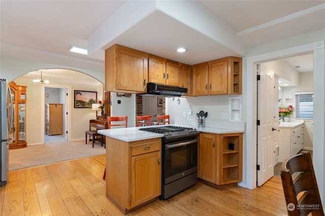 kitchen with arched walkways, stainless steel appliances, ventilation hood, and open shelves