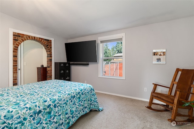 bedroom with carpet floors, vaulted ceiling, and baseboards