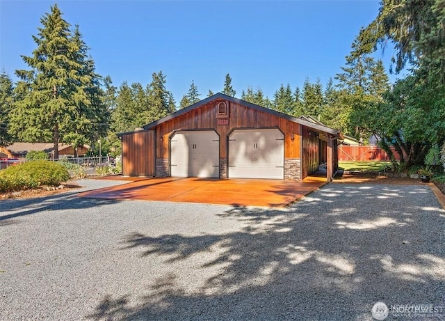 detached garage featuring fence