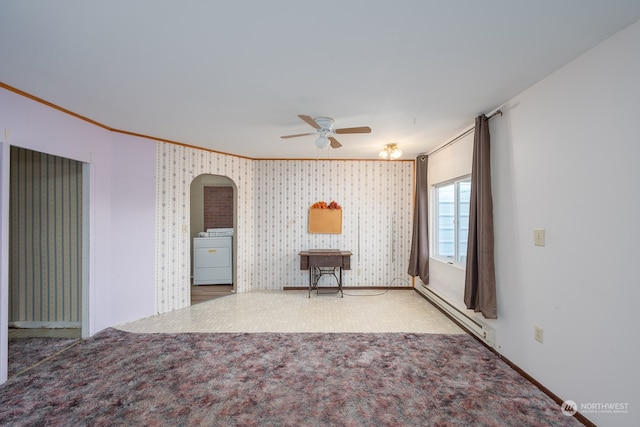 carpeted empty room with ceiling fan, baseboard heating, washer / clothes dryer, and ornamental molding