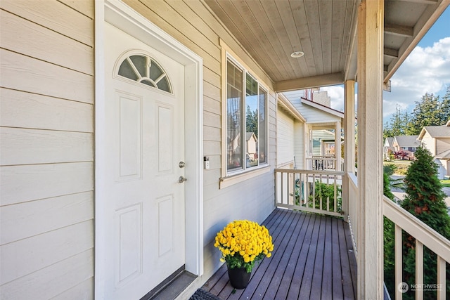 view of exterior entry with covered porch