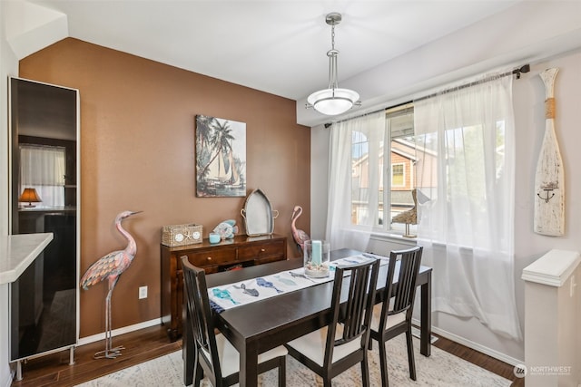 dining room featuring hardwood / wood-style floors and vaulted ceiling