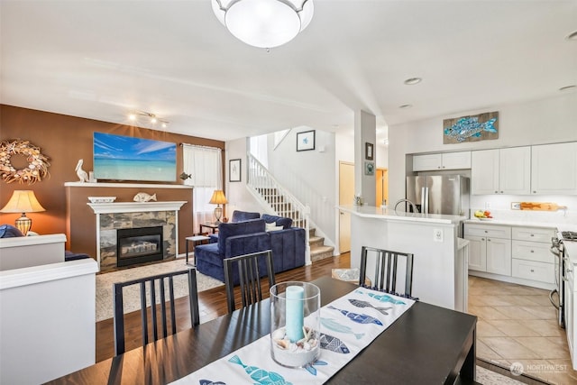 3821 NE 14th Pl, Renton, WA 98056 - dining area with stairs and a fireplace with flush hearth