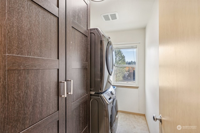 laundry area with stacked washer / drying machine