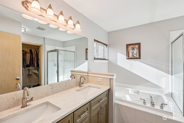 bathroom featuring independent shower and bath and vanity