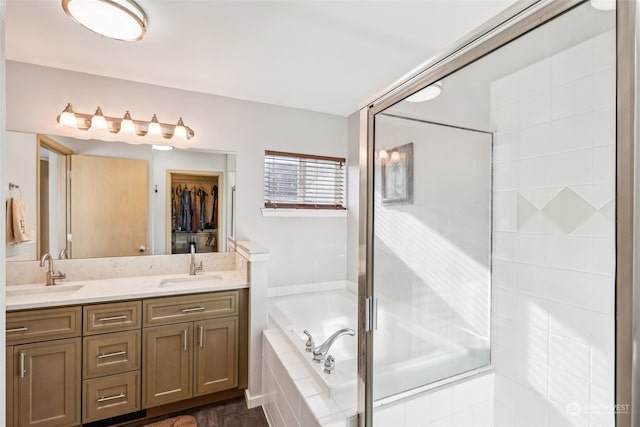 bathroom featuring vanity and independent shower and bath