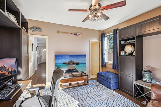 interior space with ceiling fan and dark hardwood / wood-style floors