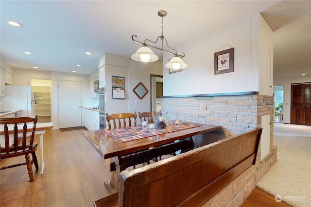 dining area with a chandelier and light hardwood / wood-style floors