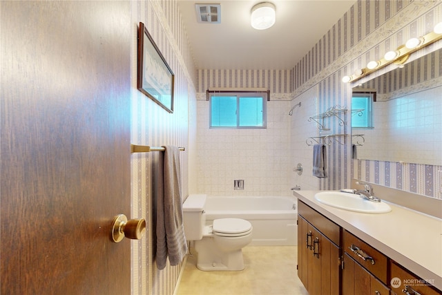 full bathroom with tile patterned floors, vanity, toilet, and tiled shower / bath