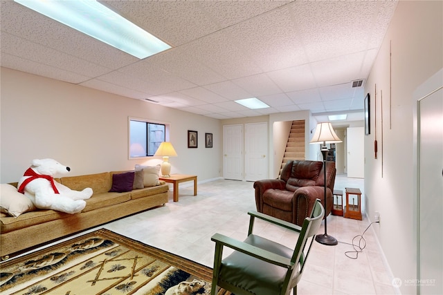 living room featuring a paneled ceiling