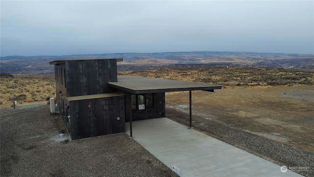 exterior space featuring a mountain view and a carport