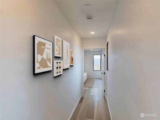 hallway with light hardwood / wood-style floors