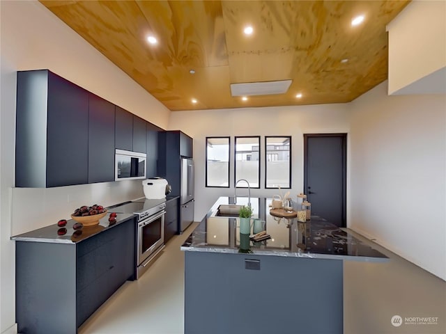 kitchen featuring dark stone countertops, sink, and appliances with stainless steel finishes