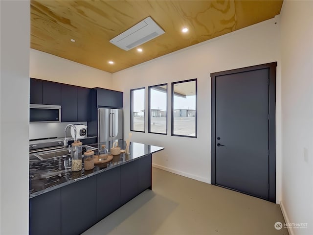 kitchen featuring dark stone countertops, sink, and appliances with stainless steel finishes