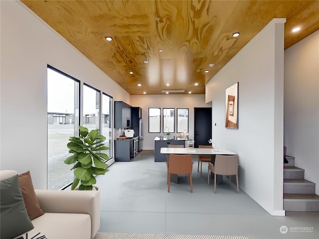 kitchen with a kitchen bar, kitchen peninsula, and wooden ceiling