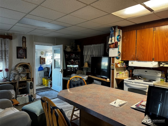 kitchen with a paneled ceiling, ventilation hood, and electric range